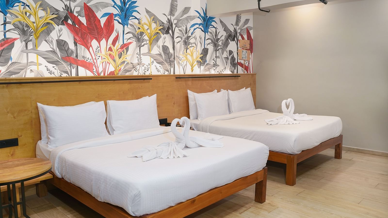 A large bed placed next to another bed in Urban Corner Room at Indie Stays Resort, Goa